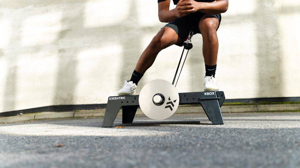 lateral squat on kBox Lite with M flywheel and platform extension foot block in an outdoor setting