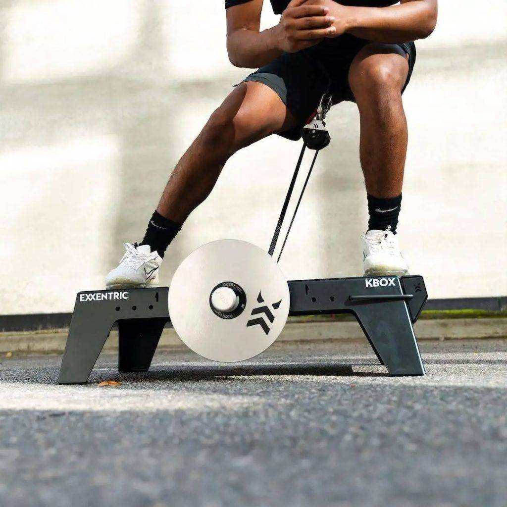 lateral squat on kBox Lite with M flywheel and platform extension foot block in an outdoor setting