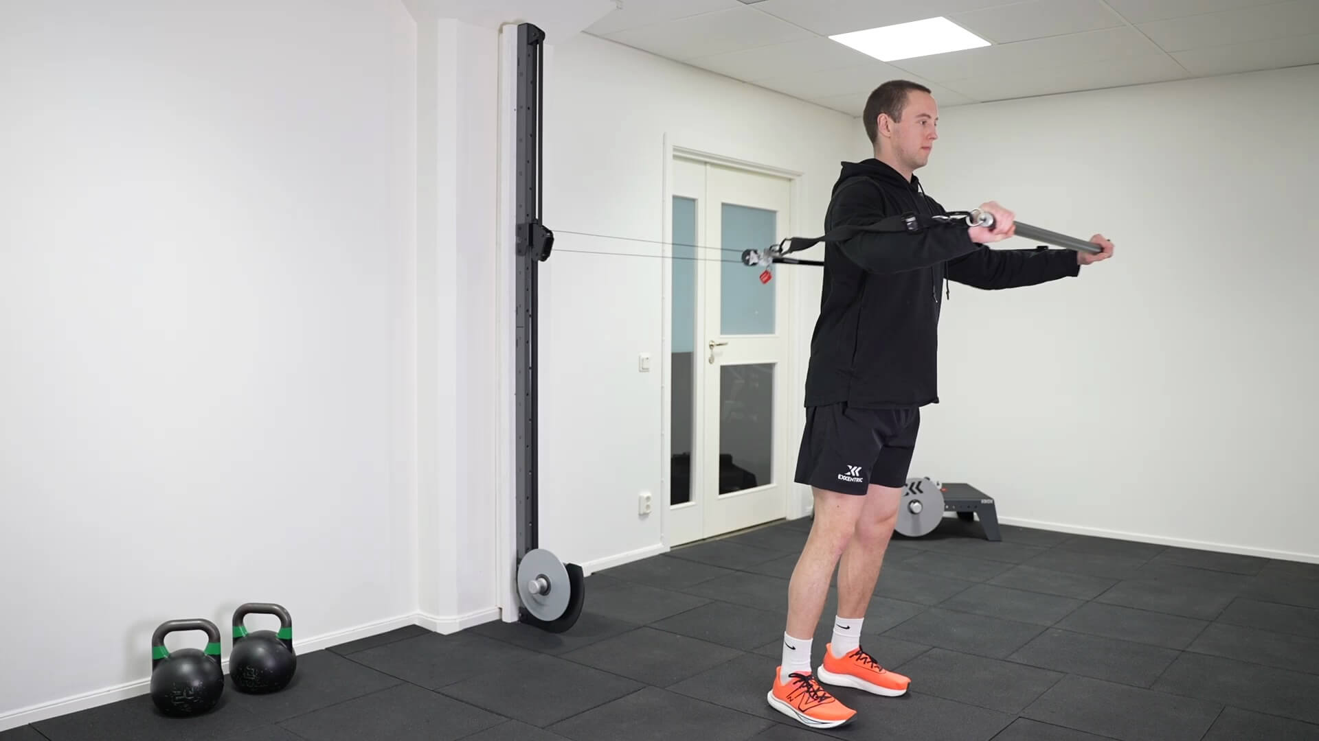 Standing kPulley chest press with double grip bar