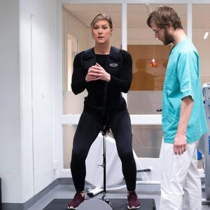 harness squat on a kBox with limited range of motion in a medical setting