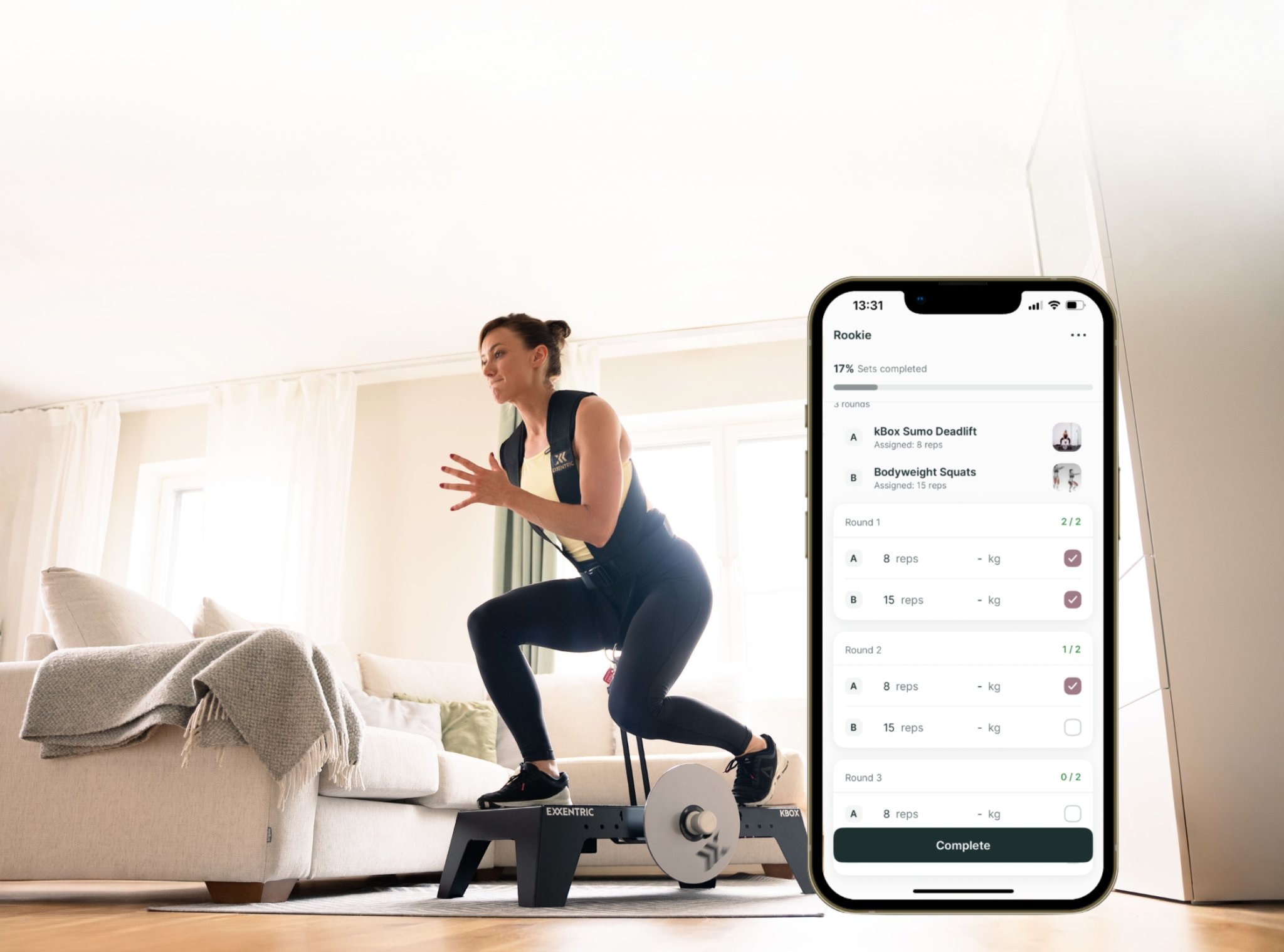 Woman doing a kBox lunge in a living room with a phone screen overlayed to display online coaching feature