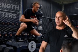 Fredrik leading a lecture with a lateral squat performed in the background